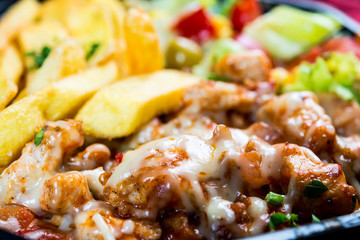Fresh chicken steak with tomatoes and french fries