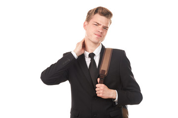 Studio portrait of teenage college student in black suit posing against white background