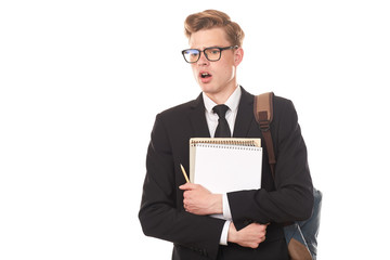 Studio portrait of teenage college student in black suit posing against white background