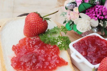 Strawberry jam with slice of bread delicious