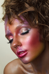 Fashion portrait of beautiful woman. Creative colorful makeup with sparkles