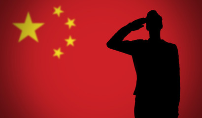 Silhouette of a soldier saluting against the china flag