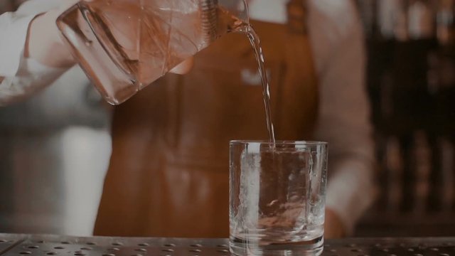 The bartender makes a cocktail