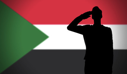 Silhouette of a soldier saluting against the sudan flag