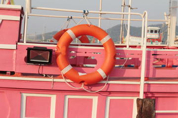 Ring buoy on the boat with the ocean