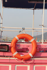 Ring buoy on the boat with the ocean