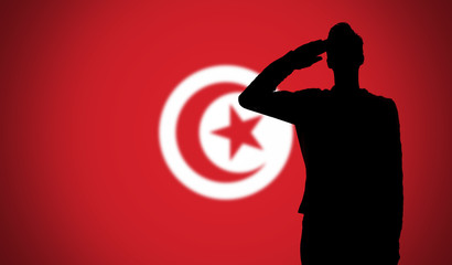 Silhouette of a soldier saluting against the tunisia flag