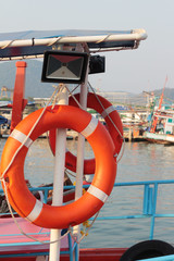 Ring buoy on the boat with the ocean