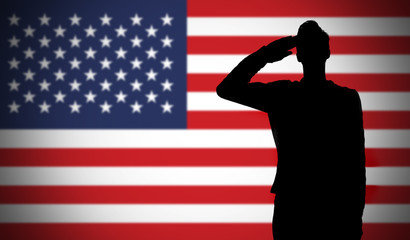 Silhouette of a soldier saluting against the american flag