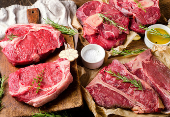 Raw beef meat on a dark wooden board.