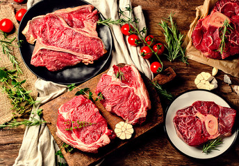 Raw beef meat on a dark wooden board.