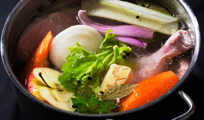 Ingredients of healthy soup in pot.