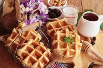 Waffles topped with honey, raisins and cashews.