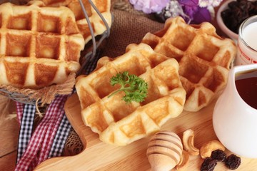 Waffles topped with honey, raisins and cashews.