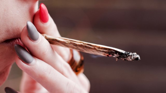 Girl smoking marijuana spliff