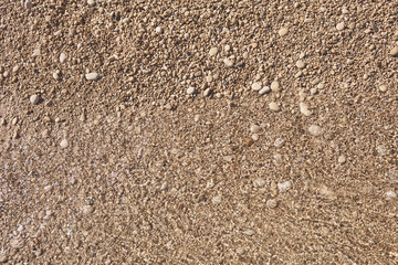 Pebbles on the beach and sea waves