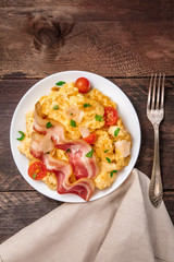 Scrambled eggs with cheese, bacon, and copy space