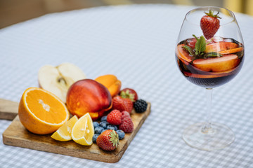 Fototapeta na wymiar Delicious Red Sangria with fruits on table
