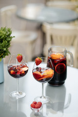 Summer drink Sangria with orange and cranberry. Selective focus. Copy space