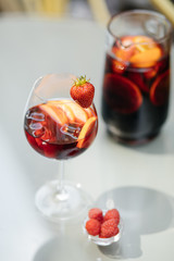 Summer drink Sangria with orange and cranberry. Selective focus. Copy space