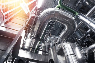 Equipment, cables and piping as found inside of a modern industrial power plant