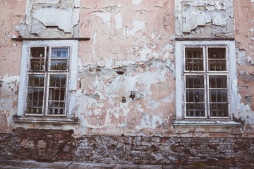 Two old windows with white lattice in vintage wall. Film effect