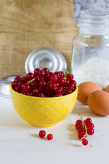 Red currants in the jar. Gray background.