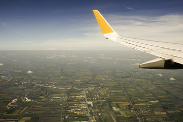 airplane wing in the sky and  top view of City landscape ,View shooting from below
