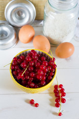 Red currants in the jar. Gray background.