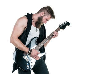Obraz premium KIEV, UKRAINE - May 03, 2017. Charismatic and stylish man with a beard playing an electric guitar on a white isolated background. Horizontal frame
