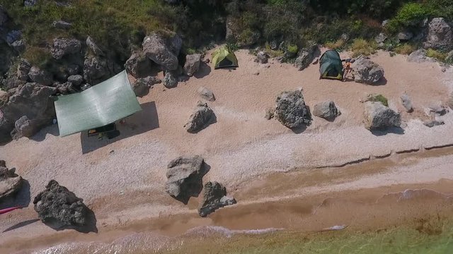 Aerial: Camping Tents on a Sandy Beach. HD Slowmotion Shot From Above. Crimea, Russia.