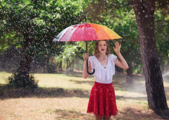 attractive young blond woman with umbrella