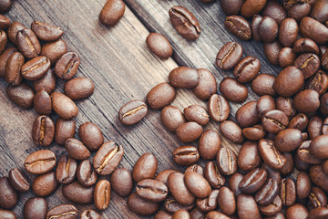 Coffee seeds on wooden surface texture. 