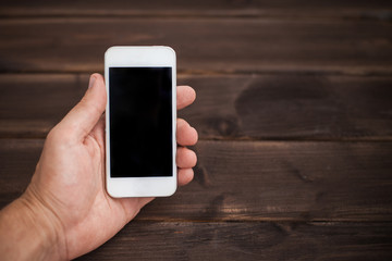 Wooden table and empty copy space screen mobile phone background.