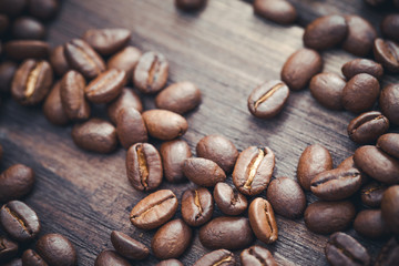 Coffee seeds on wooden surface background.