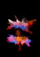 Multi cloud blasting  powder paint and flour combined, explode in front of a black background to give off fantastic multi color forms.