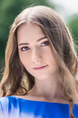 beautiful smiling girl looking at you against green background