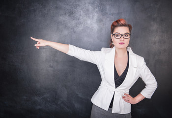 Serious woman teacher pointing out