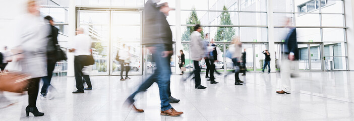 blurred business people walking in a modern hall