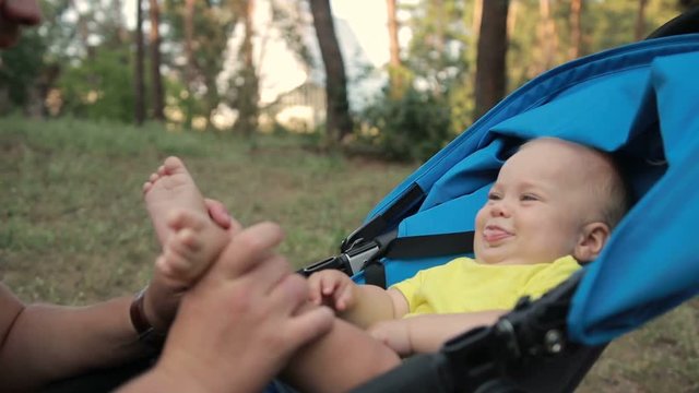 Portrait of father kissing baby son's feet