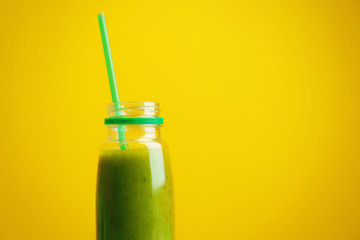 Bottle with fresh healthy green smoothie on color background