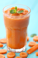 Glass with fresh tasty carrot smoothie on table