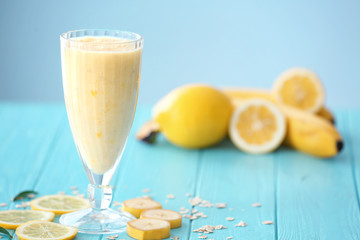 Glass with fresh fruit smoothie on table