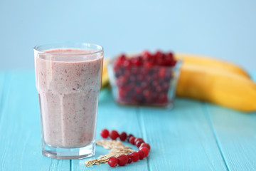 Glass with fresh tasty smoothie on table