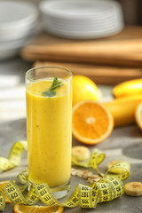 Glass with fresh tasty fruit smoothie on table