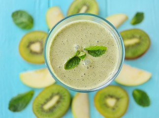 Glass with fresh tasty fruit smoothie on table