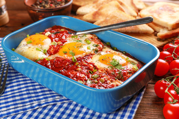 Dish with eggs in purgatory on table