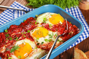 Dish with eggs in purgatory on table