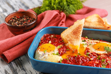 Dish with eggs in purgatory on table