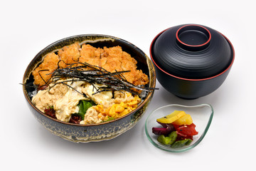Deep fried breaded pork (tonkatsu) topped with egg on steamed rice. (Katsudon ) on white background